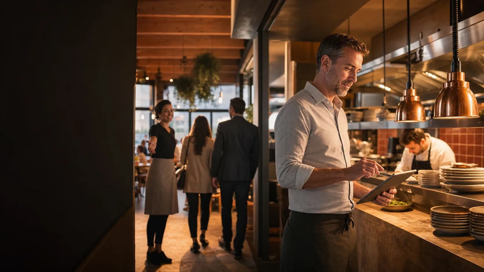 Restaurant owner reviewing service operations while the team welcomes guests